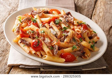 Traditional Italian Pasta With Baked Shredded Pork, Tomatoes And Herbs Close-up. Horizontal