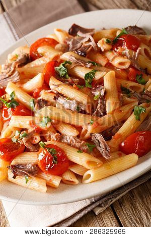 Penne Pasta With Pulled Pork, Cheese, Tomato Sauce Close-up On A Plate. Vertical
