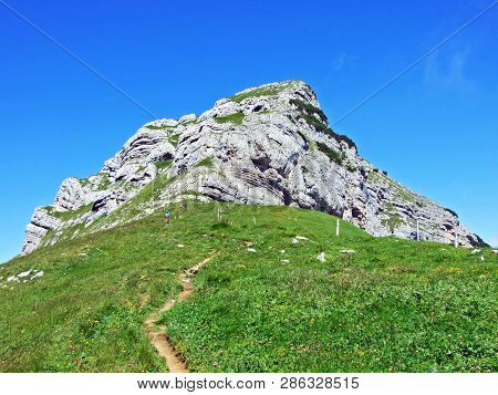 Mountain Hikers On The Alpine Peak Of Margelchopf And In The Alviergruppe Mountain Range - Canton Of