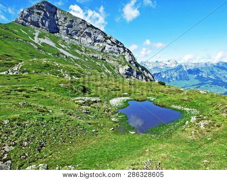 Mountain Hikers On The Alpine Peak Of Margelchopf And In The Alviergruppe Mountain Range - Canton Of