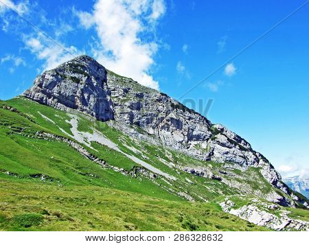 Mountain Hikers On The Alpine Peak Of Margelchopf And In The Alviergruppe Mountain Range - Canton Of