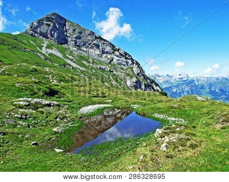 Mountain Hikers On The Alpine Peak Of Margelchopf And In The Alviergruppe Mountain Range - Canton Of