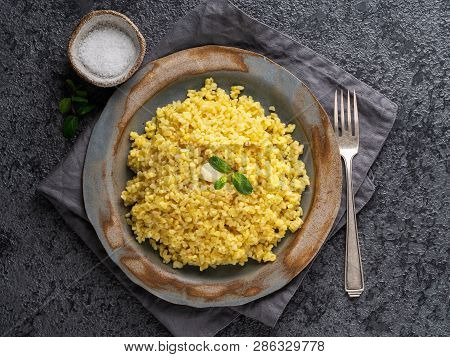Bulgur Wheat. Boiled Bulghur Cereal In Plate On Dark Grey Stone Table. Healthy Vegetarian Food, Top 