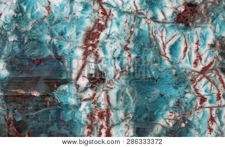 red and cyan serpentinite texture macro photo
