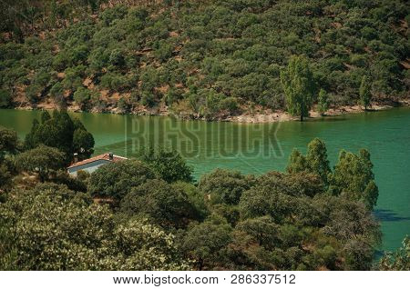 Top View Of Rocky Cliffs Covered By Trees In A Sunny Day At The Monfrague National Park. A Remarkabl