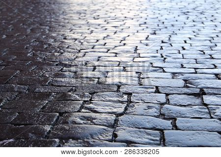 Stone Pavement Texture, Dark Dramatic Background. Cobbled Pavement, Old Masonry Road From Gabbro Sto