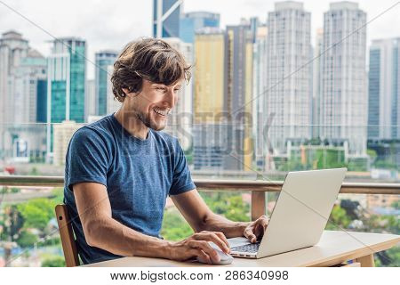Young Man Teaches A Foreign Language Or Learns A Foreign Language On The Internet On Her Balcony Aga