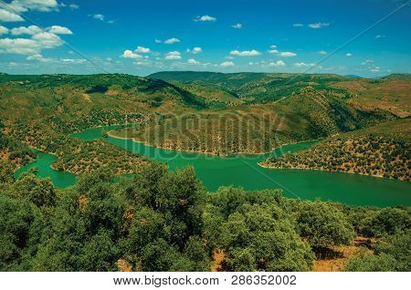 Tagus River Running Through A Valley With Hills Covered By Trees