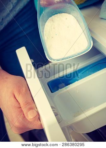 Washing Powder Detergent And Measuring Cup Pouring Into Machine. Household Duties, Clothes Laundry O
