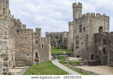 Carnarvon, Great Britain - September 14, 2014: Carnarvon Castle In Wales Is An Outstanding Example O