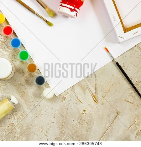 Flatlay With Bright Water Colour Paints In Small Round Containers And Bottles And Palettes As Frame,