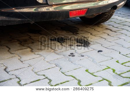 Close Up On Oil Leaking From An Old Car