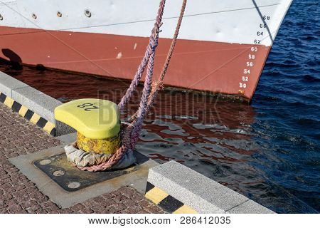 Ship Mooring Rope Moored On The Bollard. Moored Boat In The Port.  Season Of The Spring.