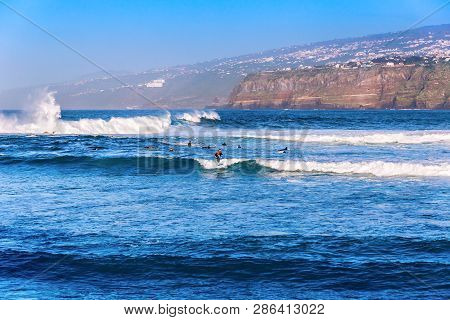 Puerto De La Cruz, Tenerife, Spain - February 8, 2019: Several Surfers In The Ocean On The Popular R