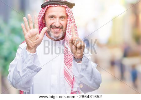 Senior arab man wearing keffiyeh over isolated background showing and pointing up with fingers number six while smiling confident and happy.