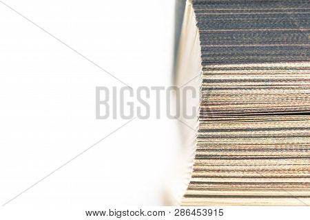 Top View Of The Fore Edge, Closed Pages Of A Bookmarked Hardcover Book Isolated On White Background.