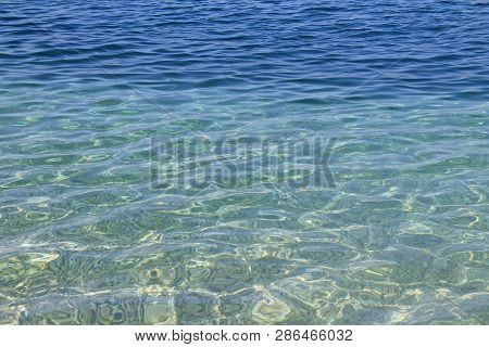 Transparent Crystal Clear Sea Water And Pebbles, Summer Sea Water Background.