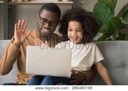 Happy Black Dad With Kid Daughter Waving Hands Making Videocall