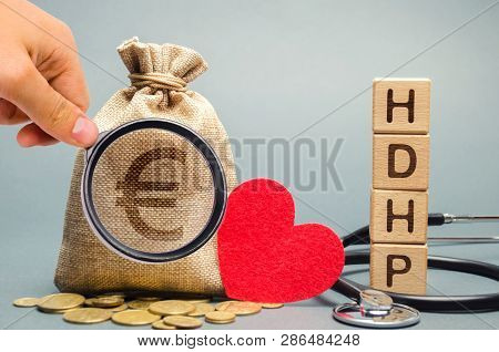 Wooden Blocks With The Word Hdhp And Money Bag With Euro Sign. High-deductible Health Plan Concept. 