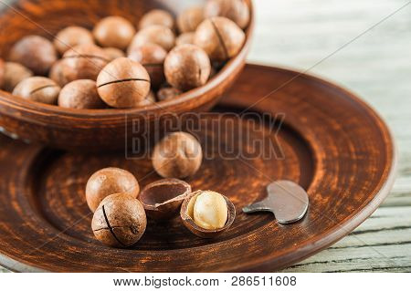 Macedonian Nuts On A Wooden Plate On The Background Of A Textural Wooden Table. Macedonian Nuts Clos
