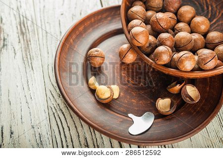 Macedonian Nuts On A Wooden Plate On The Background Of A Textural Wooden Table. Macedonian Nuts Clos