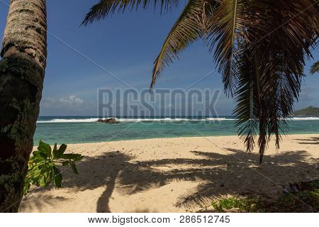 Beautiful Beach On Island Mahe, Seychelles. Turquoise Water Of The Indian Ocean And Palms On The Whi