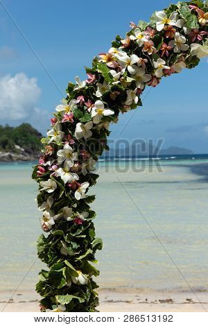 Romantic Wedding On The Beach At Mahe Island, Seychelles. Wedding Arche Decorated With Tropical Flow