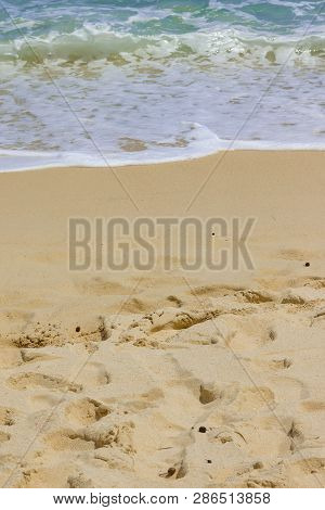 Indian Ocean And A White Sand Beach On Mahe Island, Seychelles. Water Foam Of The Wave.
