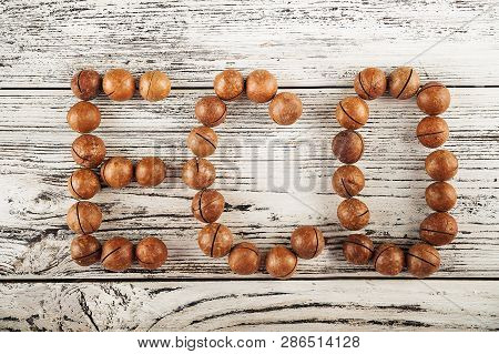 Macedonian Nuts On A Wooden Plate On The Background Of A Textural Wooden Table. Macedonian Nuts Clos
