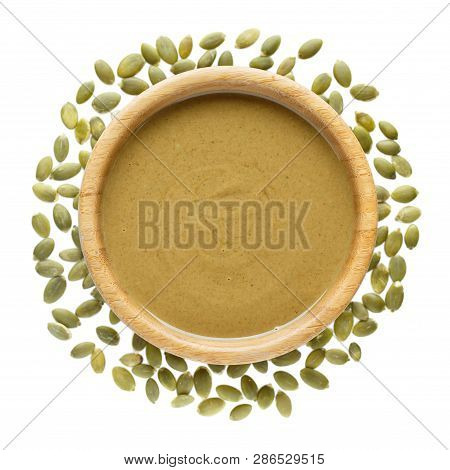 Natural Paste From Pumpkin Seeds In Wooden Bowl Isolated On White. Pumpkin Urbech, Pumpkin Seed Butt
