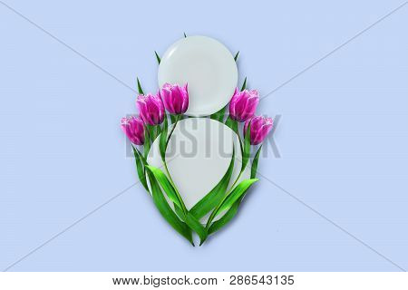 March 8 Made Up Of Plates With Tulips On A Blue Background. Copy Space. Happy Women's Day Background