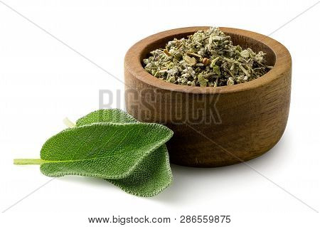 Dried Rubbed Sage In A Dark Wood Bowl Next To Fresh Sage Leaves Isolated On White.