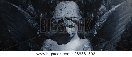 Angel Of Death. Retro Styled Ancient Statue Of Sad Angel As Symbol Of Pain, Fear And End Of Life.