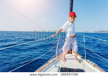 Little Boy On Board Of Sailing Yacht On Summer Cruise. Travel Adventure, Yachting With Child On Fami