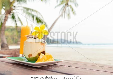 Coconut On Mango Background. Tropical Fruits. Summer Concept. Drink. Summer Concept