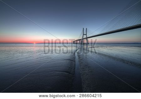 Peaceful Atmosphere At Vasco Da Gama Bridge In Lisbon During Sunrise. Ponte Vasco De Gama, Lisboa, P