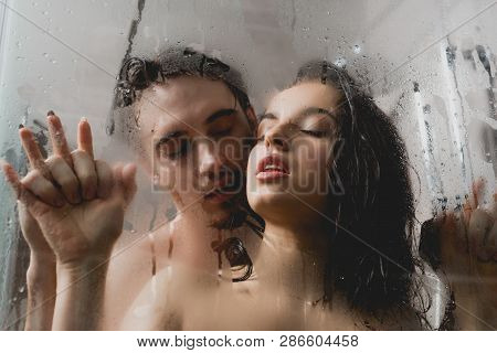 Selective Focus Of Passionate Naked Man And Attractive Woman Hugging In Shower Cabin
