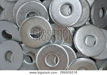 Metal Fasteners. Many Washers For Construction As An Industrial Style Background, Close-up.