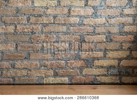 Clean Wooden Desk Against Modern Brick Wall