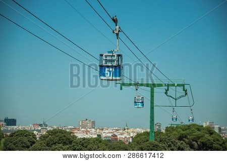 Cable Car Gondola Passing Through Big Supporting Towers Over Treetops, In A Sunny Day At The Telefer