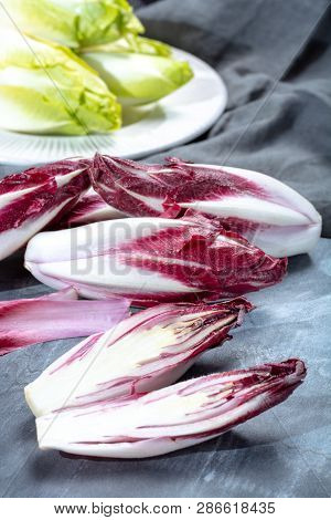 Group Of Fresh Green Belgian Endive Or Chicory And Red Radicchio Vegetables, Also Known As Witlof Sa