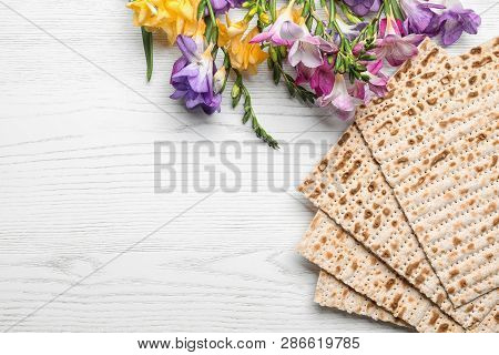 Flat Lay Composition Of Matzo And Flowers On Wooden Background, Space For Text. Passover (pesach) Se