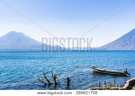 Atitlan, Toliman & San Pedro Volcanoes On Lake Atitlan With Boat Moored In Foreground, Guatemala, Ce