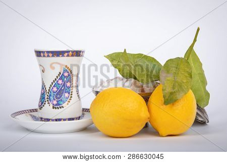 Traditional White Color  Armudu Tea Cup With National Patterns And Buta Print. Two Lemons With A Bra