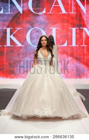 ZAGREB, CROATIA - FEBRUARY 02, 2019: Fashion model in a wedding dress walking down the runway at the Wedding fair
