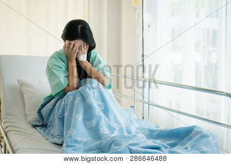 Asian Young Woman Patient Lying At Hospital Bed Feeling Sad And Depressed Worry. Disease Feeling Sic