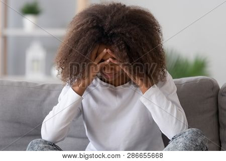 Teen Girl Sitting On Couch Crying Feels Unhappy And Upset