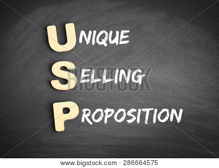 Wooden Alphabets Building The Word Usp - Unique Selling Proposition Acronym On Blackboard