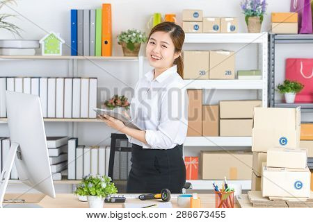 Young Beautiful, Attractive Asian Businesswoman With Pony Tail, White Shirt, Black Skirt, Hold Table