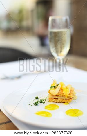 Milfey Cake With Lemon Cream On The Plate. Prosecco On The Background